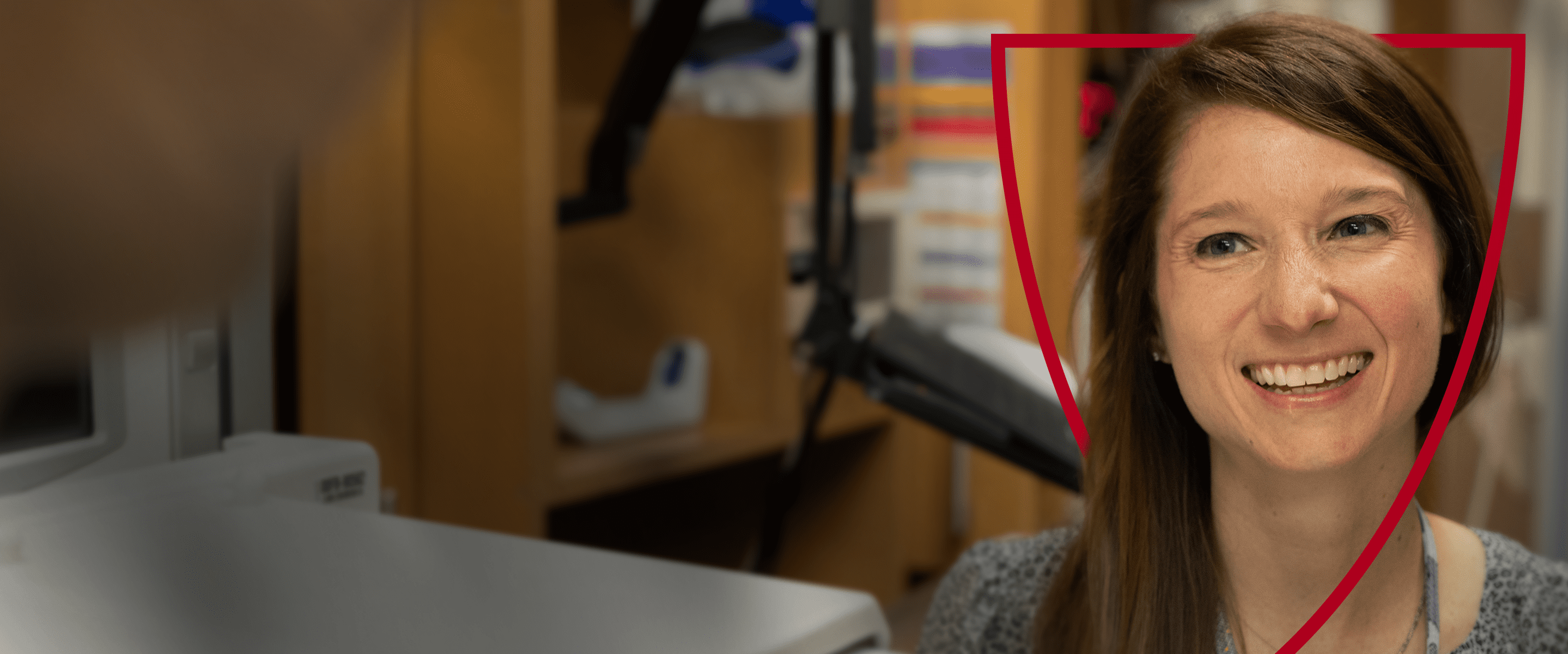 Banner Visual Alt Text, if Needed A smiling hospital administrator in an office setting.