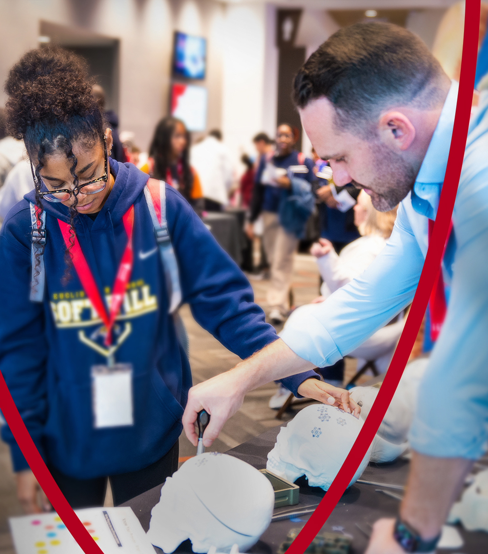 A student engages in a hands-on learning activity with a healthcare professional at a STEM event.